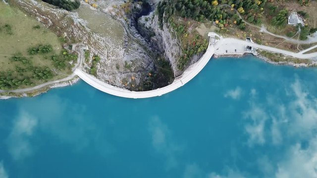 Drone aerial footage of reservoir lake and arch dam for renewable energy power plant in Switzerland Alps