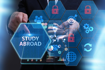Business, Technology, Internet and network concept. Young businessman working on a virtual screen of the future and sees the inscription: Study abroad