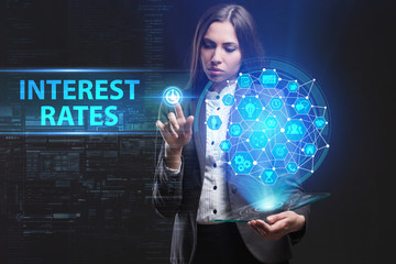 The concept of business, technology, the Internet and the network. A young entrepreneur working on a virtual screen of the future and sees the inscription: Interest rates