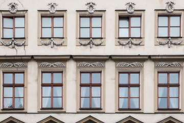 Fototapeta na wymiar Ten windows on the facade of a vintage house
