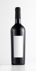 Close-up of a red wine bottle with blank label