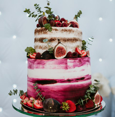 Rustic wedding cake decorated with figs and greenery