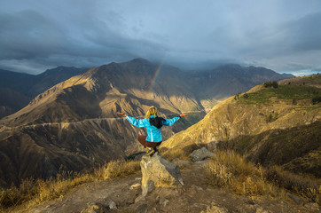 Young woman meditate above the deepest canyon Colca. Panoramic breathtaking view of peruvian...