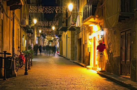 CEFALU, ITALY-JANUARY 03, 2017: Christmas lights decoration of ancient narrow street. People are walking