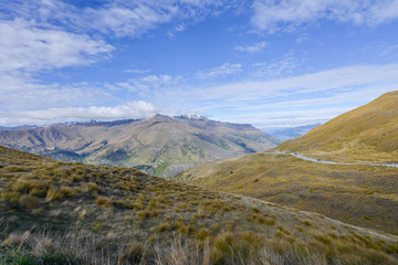 Valley is covered with brown grass in New Zealand