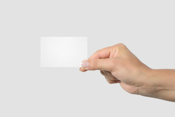Mockup of female hand holding a Business Card isolated on light grey background. Size 85x 55 mm.