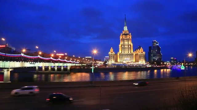  Hotel Ukraine and Novoarbatsky bridge over the Moskva river in the evening in Moscow