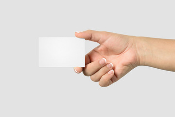 Mockup of female hand holding a Business Card isolated on light grey background. Size 85x 55 mm.