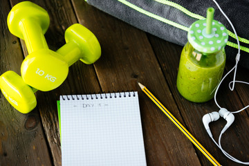 Fitness workout routine blank notebook and detox smoothie