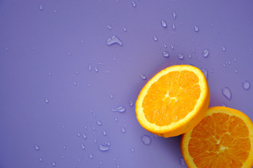 Fototapeta na wymiar Cut Half of Navel Orange on Purple Background