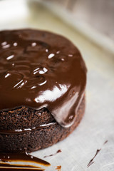 Creamy cake with chocolate glaze on the rustic background. Selective focus. Shallow depth of field.