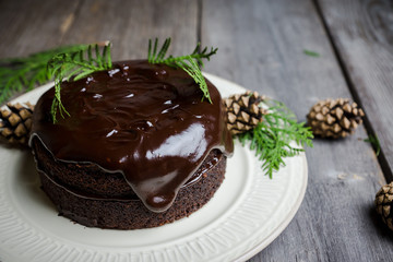Creamy cake with chocolate glaze on the rustic background. Selective focus. Shallow depth of field.