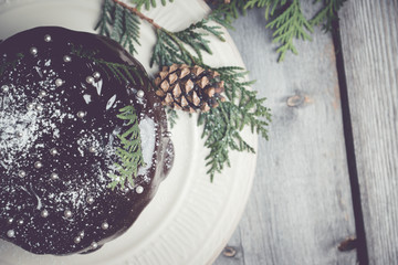 Creamy cake with chocolate glaze on the rustic background. Selective focus. Shallow depth of field. Toned image.