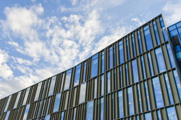 Fototapeta na wymiar Texture of modern building from glass with blue sky