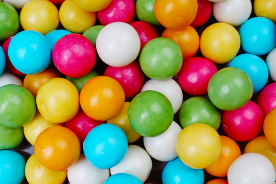 Bubble gum chewing gum texture. Rainbow multicolored gumballs chewing gums as background. Round sugar coated candy dragee bubblegum texture. Food photography. Colorful bubblegums wallpaper. Texture