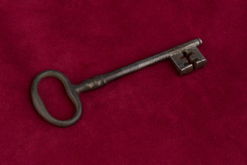 key on red velvet pillow