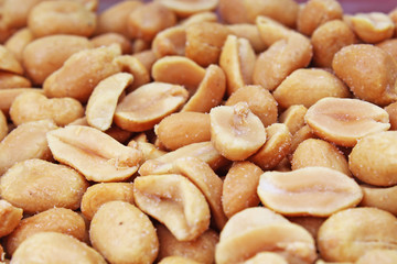 Fototapeta na wymiar Peeled peanuts background food photography in studio. Close up macro peanuts photo. Beautiful salted roasted peanuts pattern concept. Texture background.