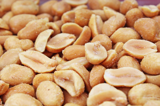 Peeled peanuts background food photography in studio. Close up macro peanuts photo. Beautiful salted roasted peanuts pattern concept. Texture background.