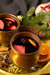 Warm mulled wine for Christmas days, prepared with apple, orange and spices.