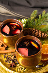 Warm mulled wine for Christmas days, prepared with apple, orange and spices.