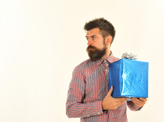 Surprise and holiday gift concept. Guy in plaid shirt