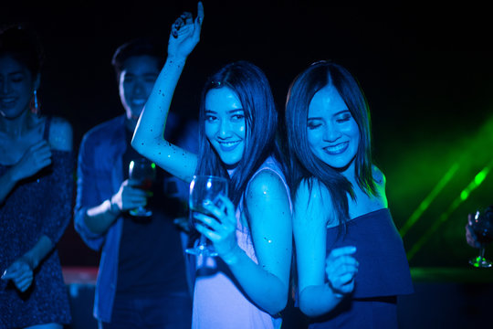 Night club and DJ party with friends, dancing and celebrating concept