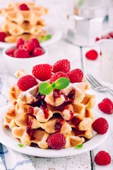 Homemade waffles with fresh raspberries for breakfast