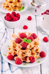 Homemade waffles with fresh raspberries for breakfast