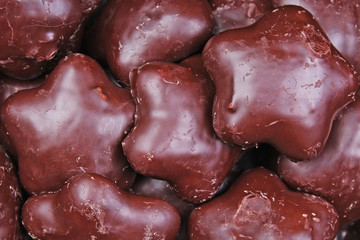 Gingerbread. Chocolate coated gingerbreads as background. Flower shaped gingerbread texture pattern. Cake texture. Cake background Texture background.