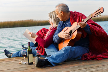 Happy senior couple enjoying time together by the lake.