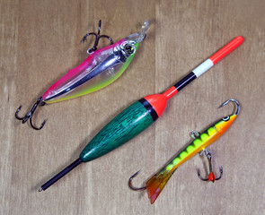 spinners for a bait of fish and float on wooden background