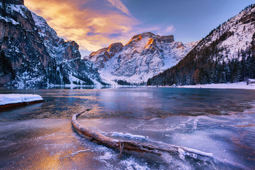 winter sunrise with colorful cloudscape over Lago di Braies, Dolomites, Italy - obrazy, fototapety, plakaty