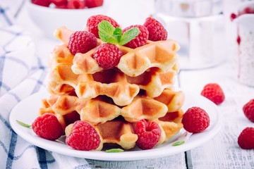 Homemade waffles with fresh raspberries for breakfast