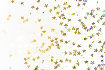 Fototapeta na wymiar Gold stars confetti on white background