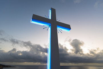 Neon cross on the sky background, cross against blue sky