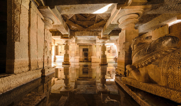Flooded underground Shiva temple with water reflection in Hampi, Karnataka, India.