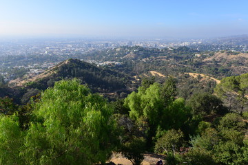 Fototapeta na wymiar The Hollywood Hills overlooking a misty Los Angeles in the early morning 