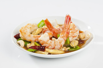 cajun Shrimps with cashew nuts stir fry vegetables on white plate with white background 