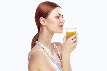 Beautiful young woman on white isolated background holds a glass of fresh juice. Diet, proper nutrition