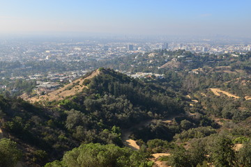 Fototapeta na wymiar The Hollywood Hills overlooking a misty Los Angeles in the early morning 