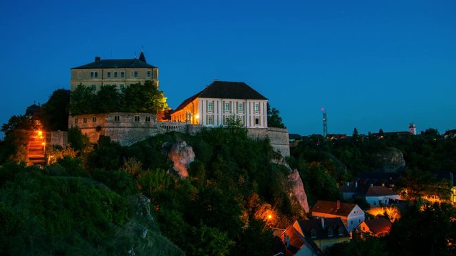 Veszprem, Hungary. View of illuminated landmarks of Castle hill at night. Time-lapse at sunset with blue sky