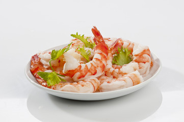 Steamed Jumbo headless shrimps with deli leaves and Lemon on white plate on white background 