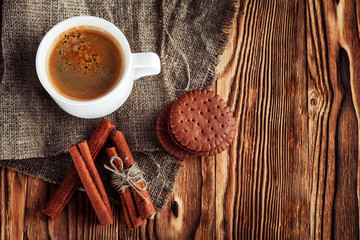 Coffee cup and cookie on wood
