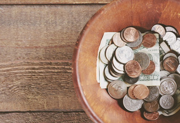 Dollars and change in a bowl