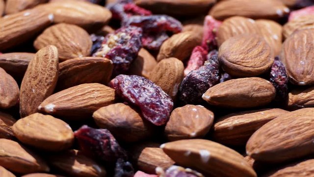 Healthy and delicious mix of almonds and dry red fruits close up. rotation of dry fruits and nuts. Food and drinks background. gastronomy concept. gourmet dietry and healthy food concept. organic food