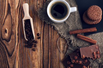 Coffee cup and cookie on wood