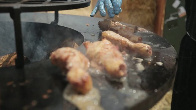 Close-up of chicken drumsticks in battered on the large barbecue