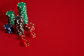 Poker chips on red background. Group of different poker chips. Casino background.