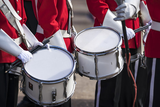 Soldiers in red uniforms with drums