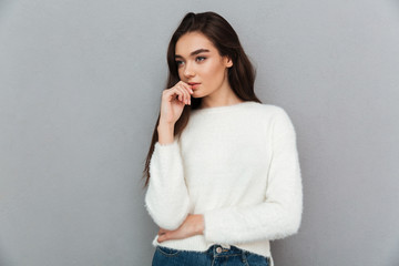 Close-up portrait of charming thoughtful brunette woman looking aside